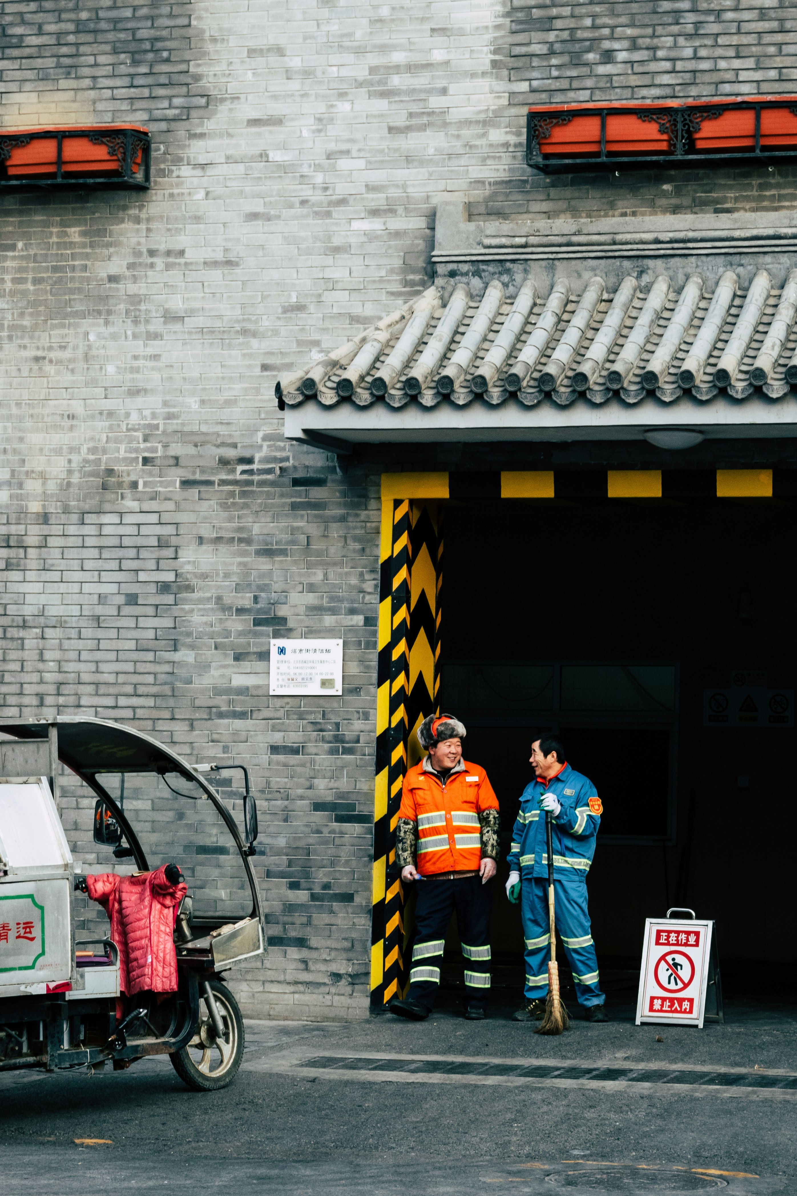 3 men standing near black and yellow door